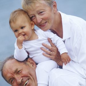 Young child being held by grandparents