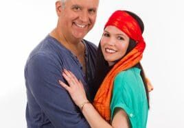 Attractive middle age couple studio portrait on a white background.